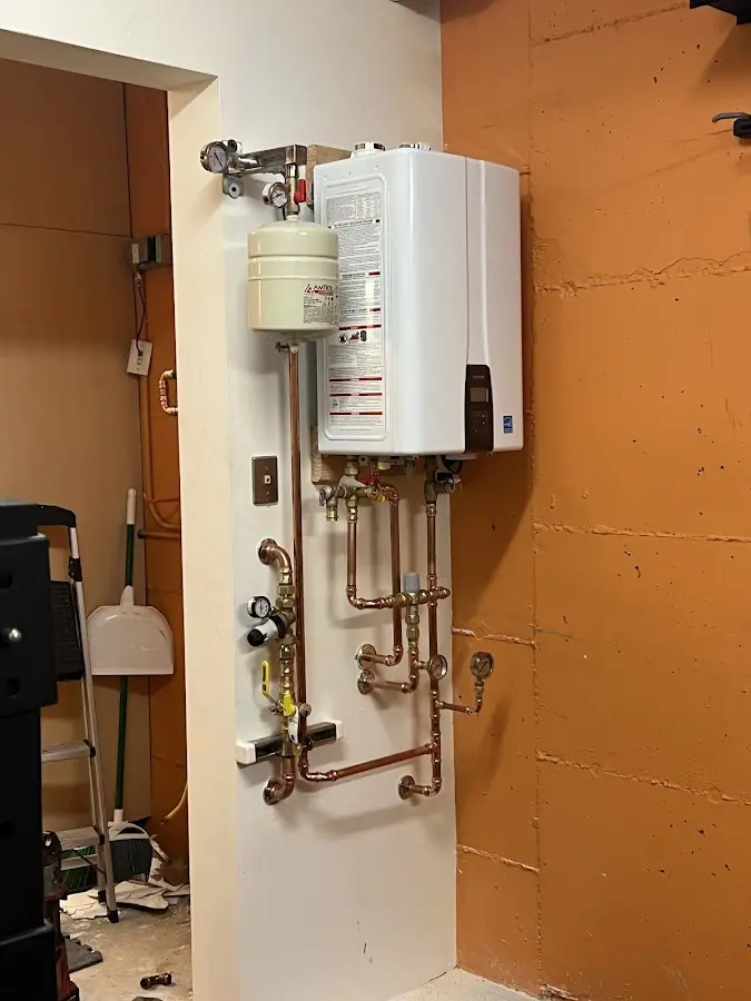 Plumbing technician inspecting water heater connections in Miami Gardens